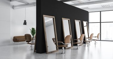Modern barber shop corner with white and black walls, tall mirrors and comfortable beige chairs. 3d rendering